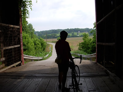 Cyclist in covered bridge.
